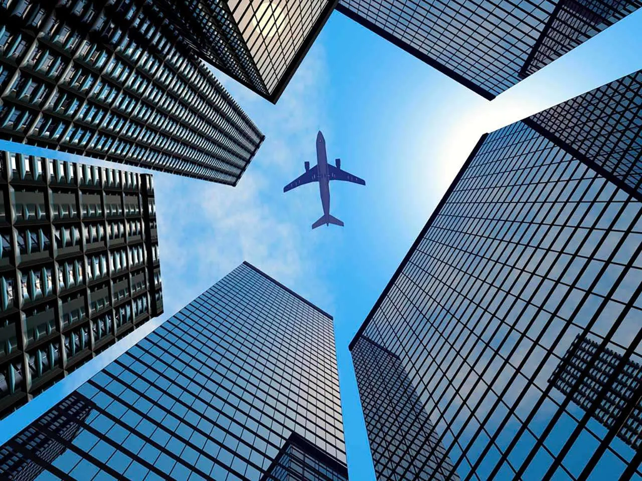 Фотообои в интерьере самолет в синем небе и мегаполис  9-368 фото